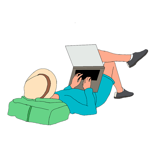 A freelancer works on his laptop as he lies on his back in comfort.